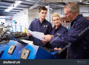 stock photo engineer teaching apprentices to use tube bending machine 165341906