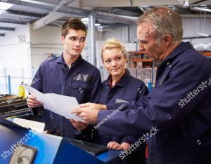 stock photo engineer teaching apprentices to use tube bending machine 165341906 copy