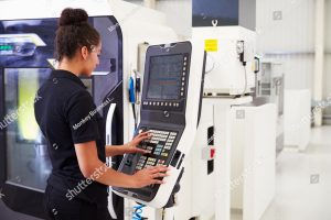 stock photo female engineer operating cnc machinery on factory floor 305421299