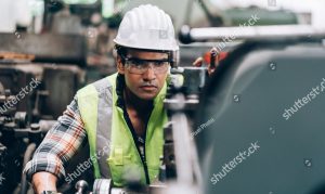 stock photo man at work mechanical engineer man in hard hat wearing safety jacket working in heavy industry 1810113856