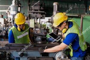 stock photo two asian engineer male worker maintaining machine lathe metal at the industry factory group of 1966276384