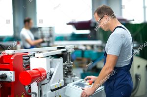 stock photo worker on the machine 226005241