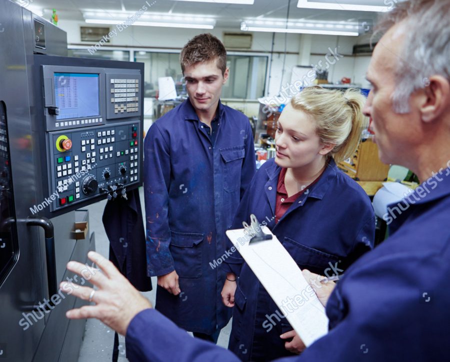 stock photo engineer teaching apprentices to use computerized lathe 165333119 1 4