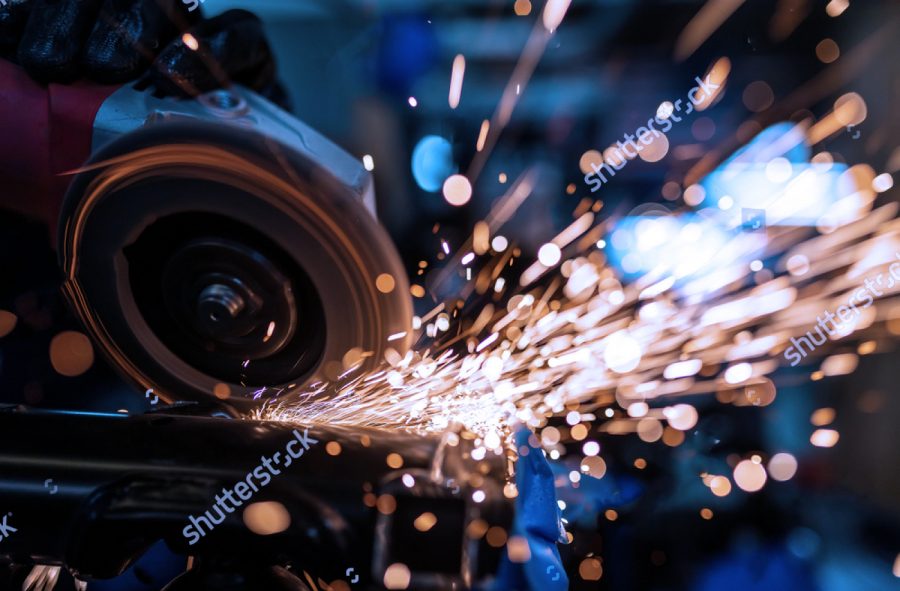 stock photo worker cutting grinding and polishing motorcycle metal part with sparks indoor workshop close up 1458278249 1